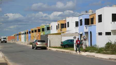 homes of paraiso maya, workers and the garbage truck in the distance. 